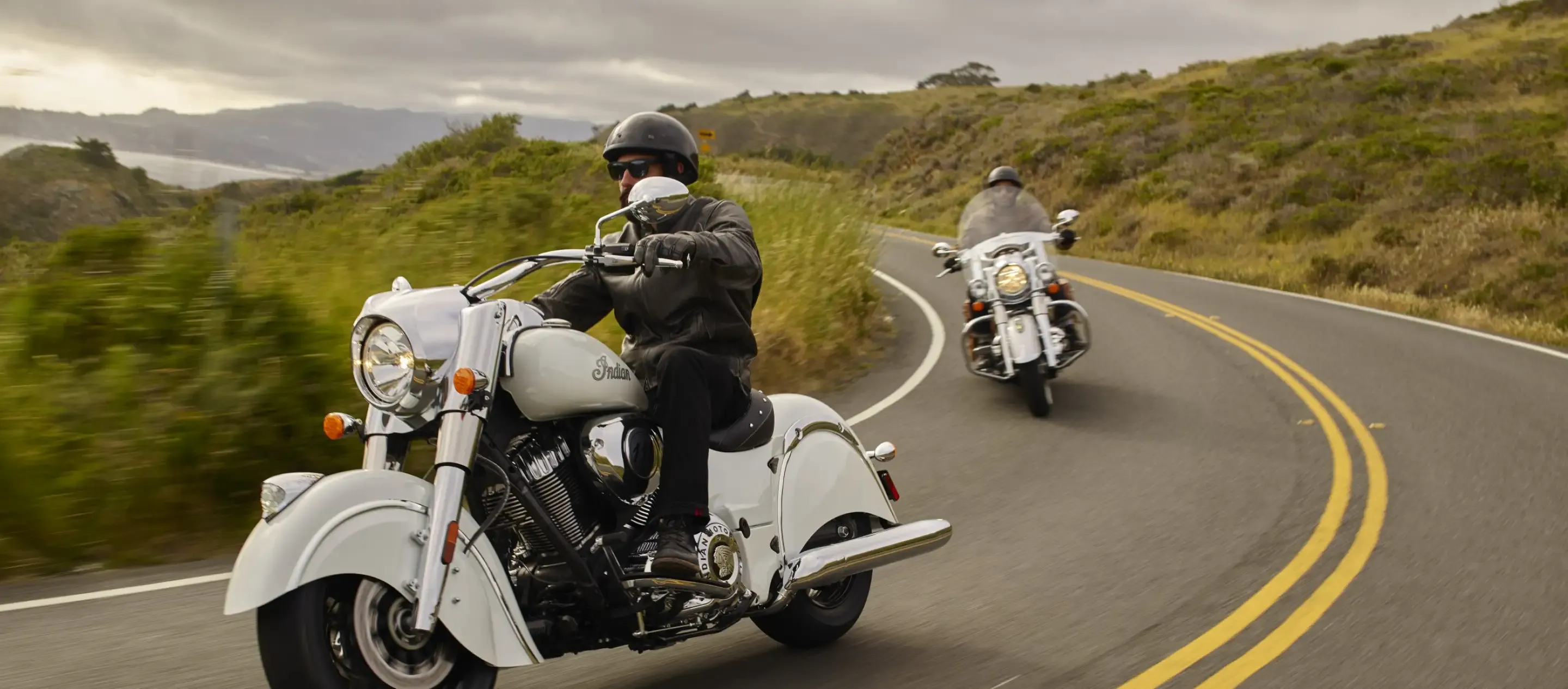 Two Motorcyclist riding through the countryside.